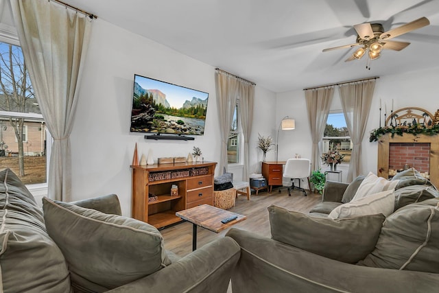 living room featuring light wood-type flooring and ceiling fan