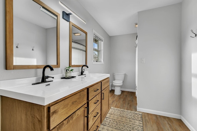 full bath with wood finished floors, baseboards, and a sink