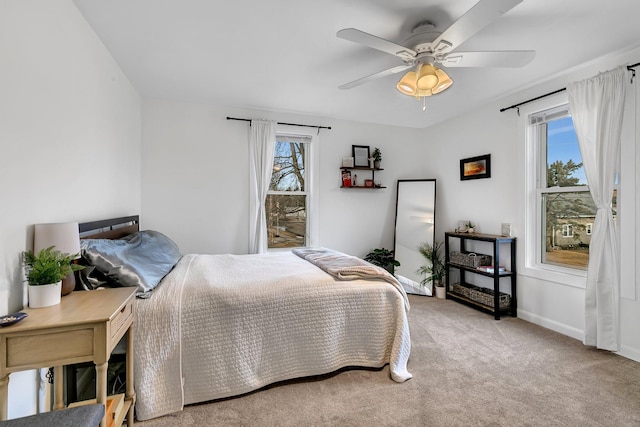 bedroom featuring baseboards, carpet floors, and ceiling fan