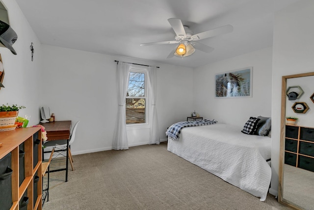 carpeted bedroom featuring baseboards and ceiling fan