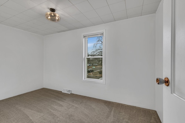 spare room with visible vents and carpet