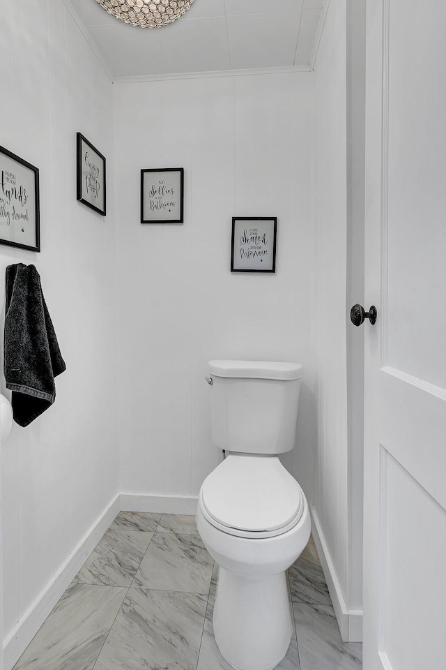 bathroom featuring marble finish floor, toilet, and baseboards