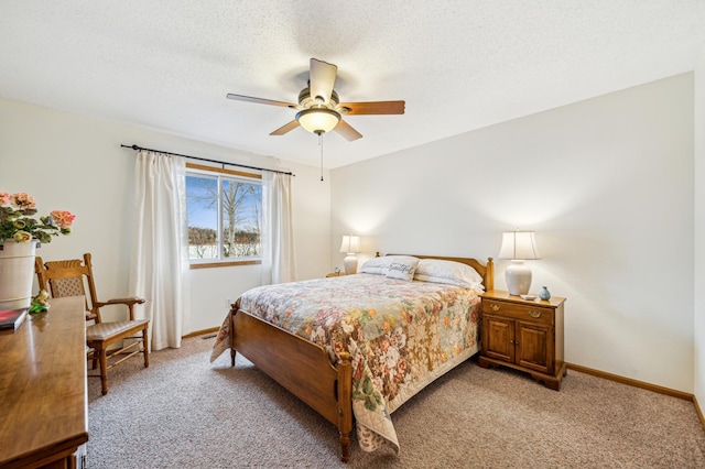 bedroom with light carpet, a ceiling fan, baseboards, and a textured ceiling