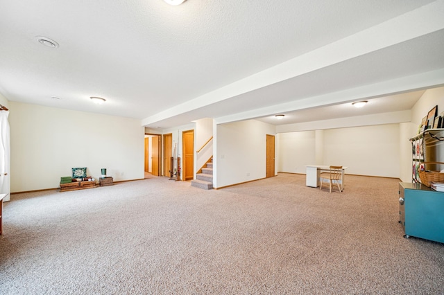 below grade area with carpet, stairway, and baseboards