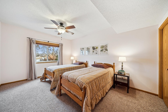 bedroom featuring light carpet, ceiling fan, a textured ceiling, and baseboards