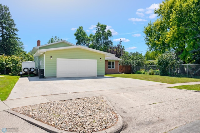 ranch-style house featuring a front lawn and a garage