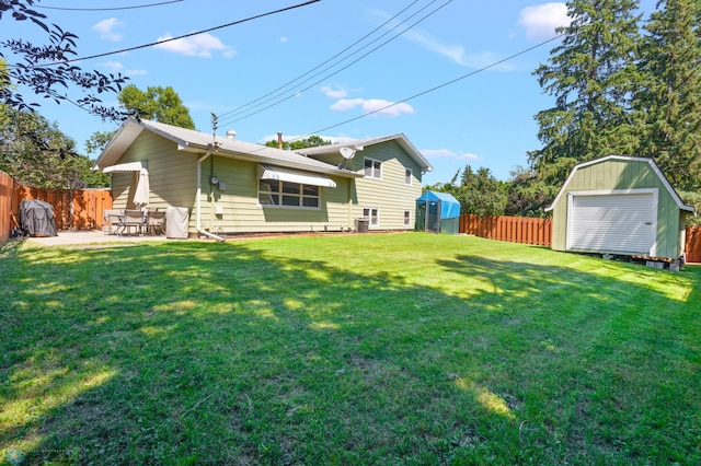 back of house featuring a shed, a patio, and a lawn