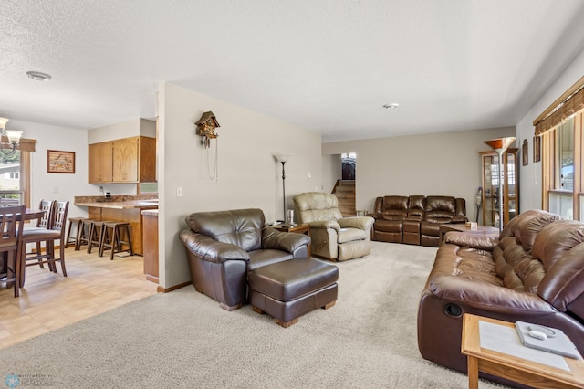 living room featuring a wealth of natural light, a textured ceiling, and light colored carpet