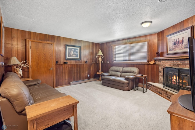 living room with a baseboard radiator, a textured ceiling, light carpet, wood walls, and a brick fireplace