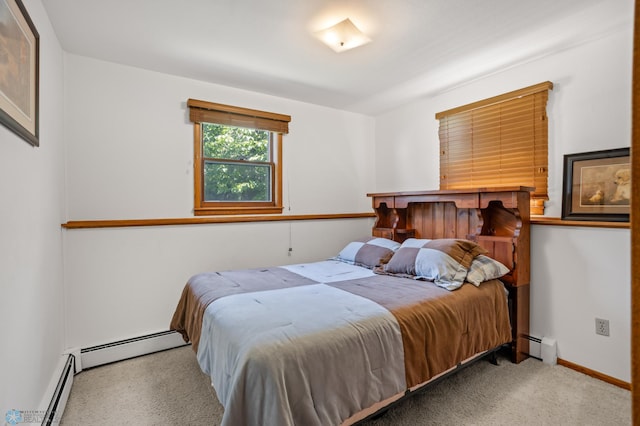 bedroom with a baseboard radiator and light carpet