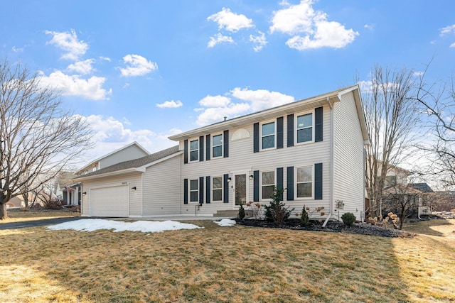 colonial home with an attached garage and a front lawn