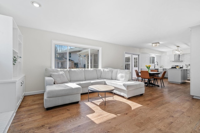 living area with plenty of natural light, recessed lighting, and wood finished floors