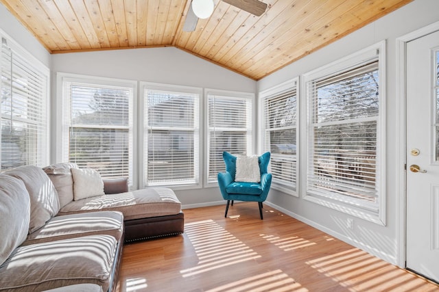 sunroom featuring wood ceiling, a ceiling fan, and vaulted ceiling