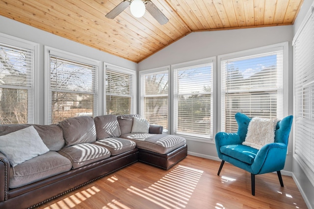 sunroom with wood ceiling, a ceiling fan, and vaulted ceiling