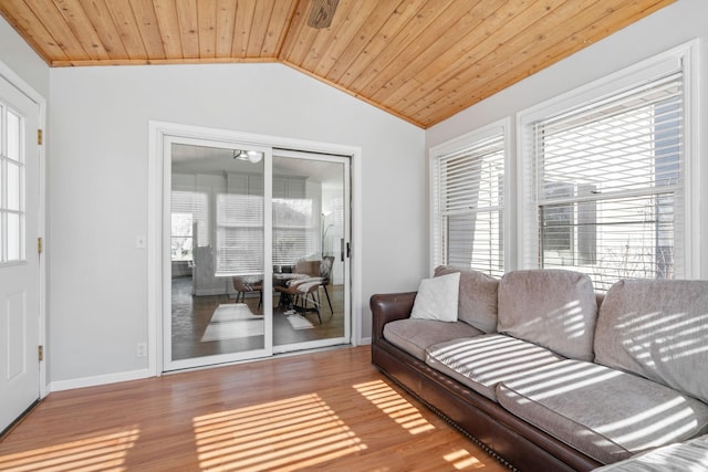 living room featuring wooden ceiling, a wealth of natural light, wood finished floors, and lofted ceiling