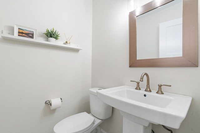 bathroom featuring toilet and a sink