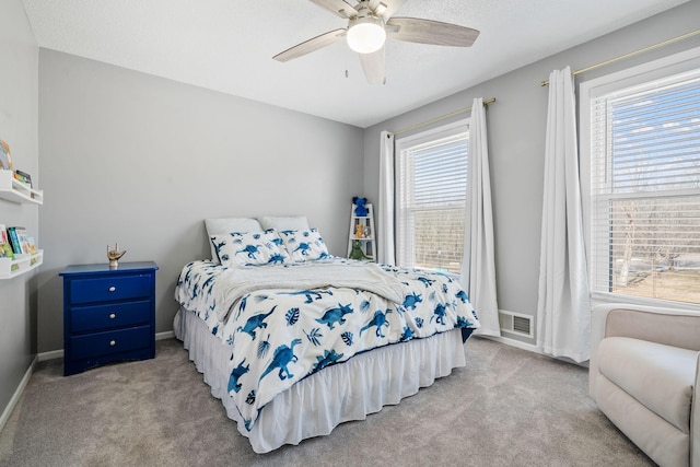 bedroom with visible vents, baseboards, carpet, and a ceiling fan