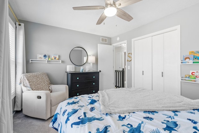 carpeted bedroom with a ceiling fan, visible vents, and a closet