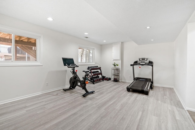 exercise area with recessed lighting, light wood-style floors, and baseboards