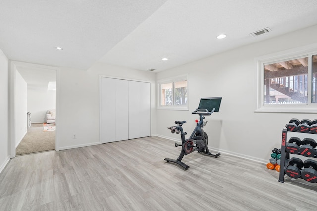 workout room featuring visible vents, a textured ceiling, wood finished floors, recessed lighting, and baseboards