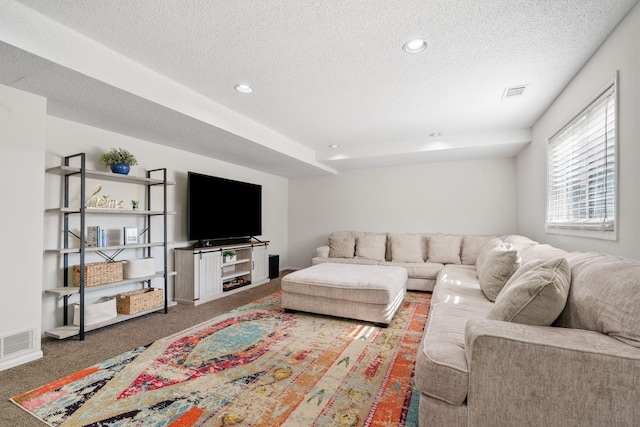 carpeted living room featuring recessed lighting, visible vents, and a textured ceiling