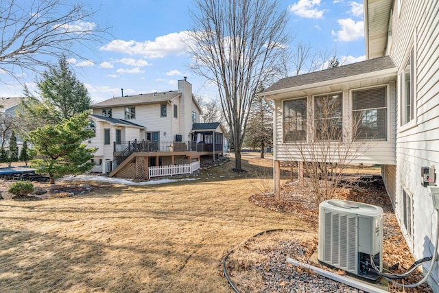 view of yard with a wooden deck, stairs, and central AC