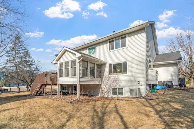 back of property with stairway, a yard, a sunroom, a deck, and central air condition unit