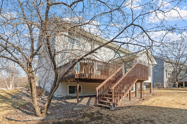 rear view of house featuring stairway and a wooden deck