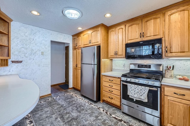 kitchen featuring stainless steel appliances and a textured ceiling