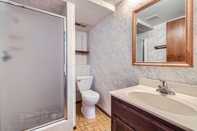 bathroom with toilet, vanity, and walk in shower