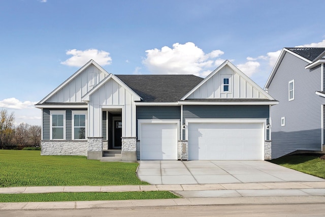 view of front of house with an attached garage, stone siding, driveway, and board and batten siding