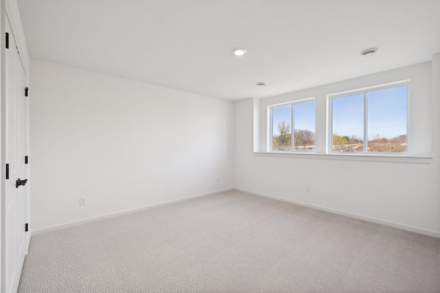 empty room with light colored carpet and baseboards