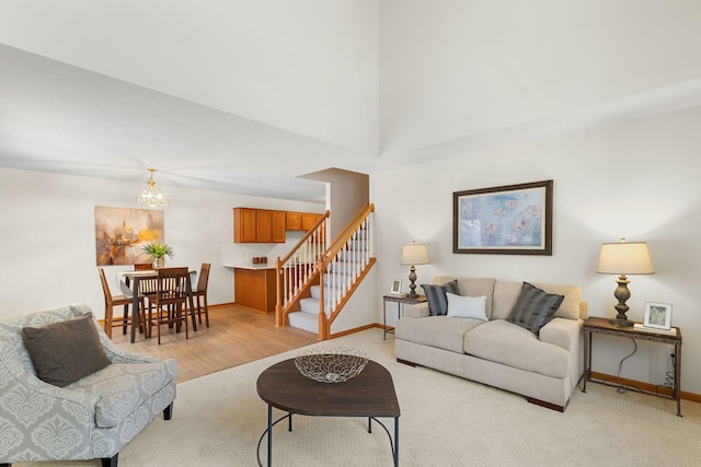 living room featuring light wood-type flooring and an inviting chandelier