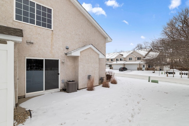 snow covered house with cooling unit