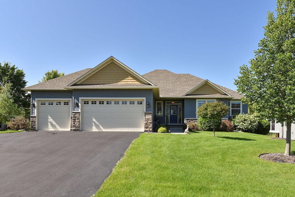 craftsman house with a garage and a front yard