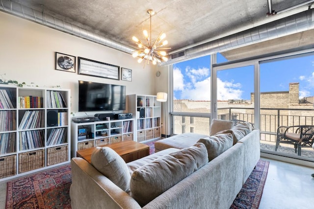 living area with concrete floors, visible vents, and a notable chandelier