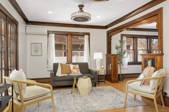 living room with ornamental molding, wood finished floors, baseboard heating, and a wall mounted AC