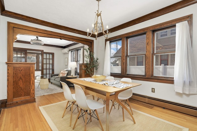 dining room featuring a wall mounted air conditioner, ornamental molding, light wood-style flooring, a notable chandelier, and a baseboard radiator