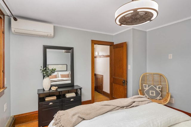 bedroom featuring an AC wall unit, wood finished floors, crown molding, baseboards, and baseboard heating