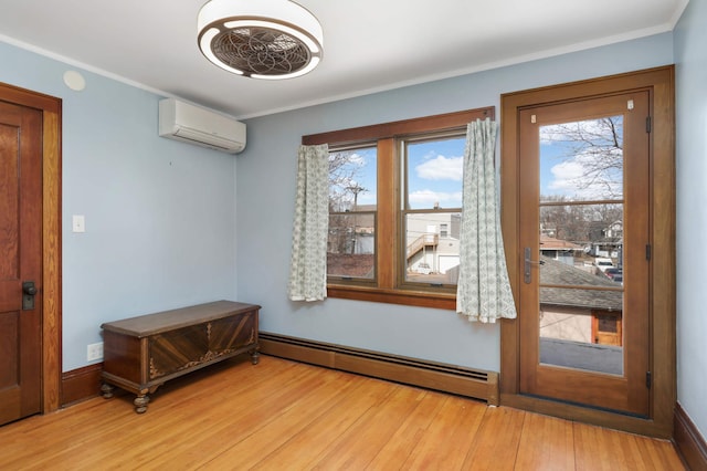 doorway with a wall unit AC, wood finished floors, a healthy amount of sunlight, and baseboard heating