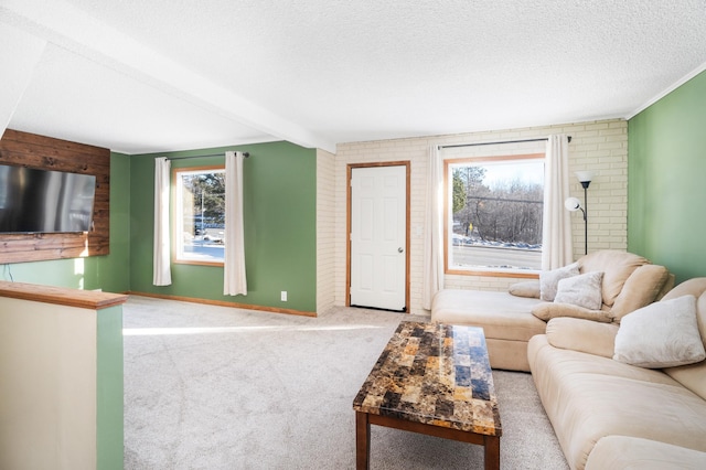 living room featuring light colored carpet, brick wall, a textured ceiling, and beam ceiling