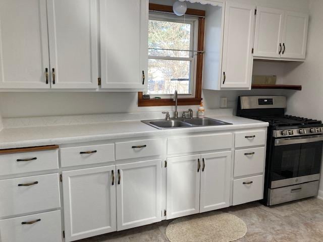 kitchen with white cabinets, sink, and stainless steel range with gas stovetop