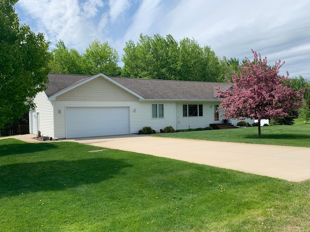 view of front of house with a garage and a front yard