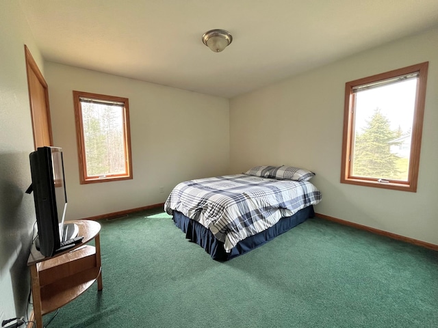 bedroom with baseboards and carpet