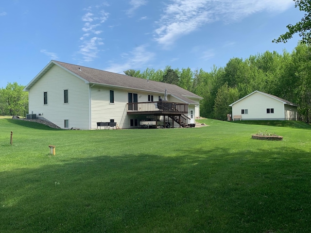rear view of house featuring a lawn, stairs, central AC unit, and a deck