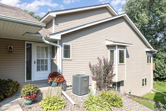 view of side of home featuring central AC unit