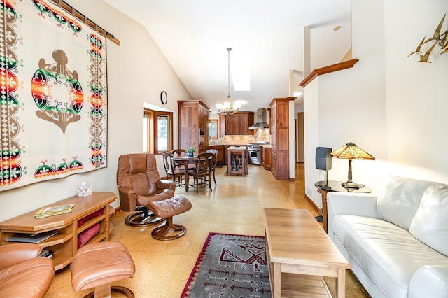 living room with an inviting chandelier and high vaulted ceiling