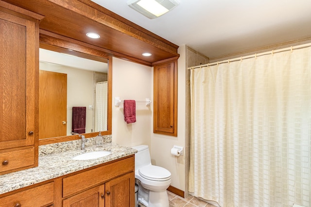 bathroom featuring vanity, tile patterned floors, and toilet