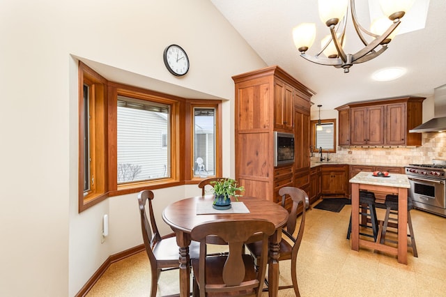 dining space featuring vaulted ceiling, sink, and an inviting chandelier