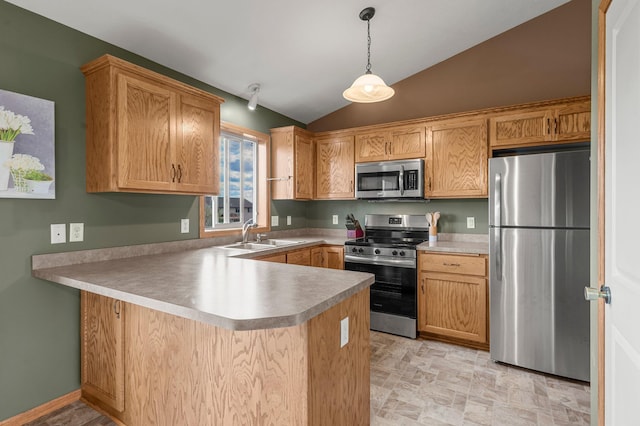 kitchen featuring decorative light fixtures, vaulted ceiling, a sink, a peninsula, and stainless steel appliances